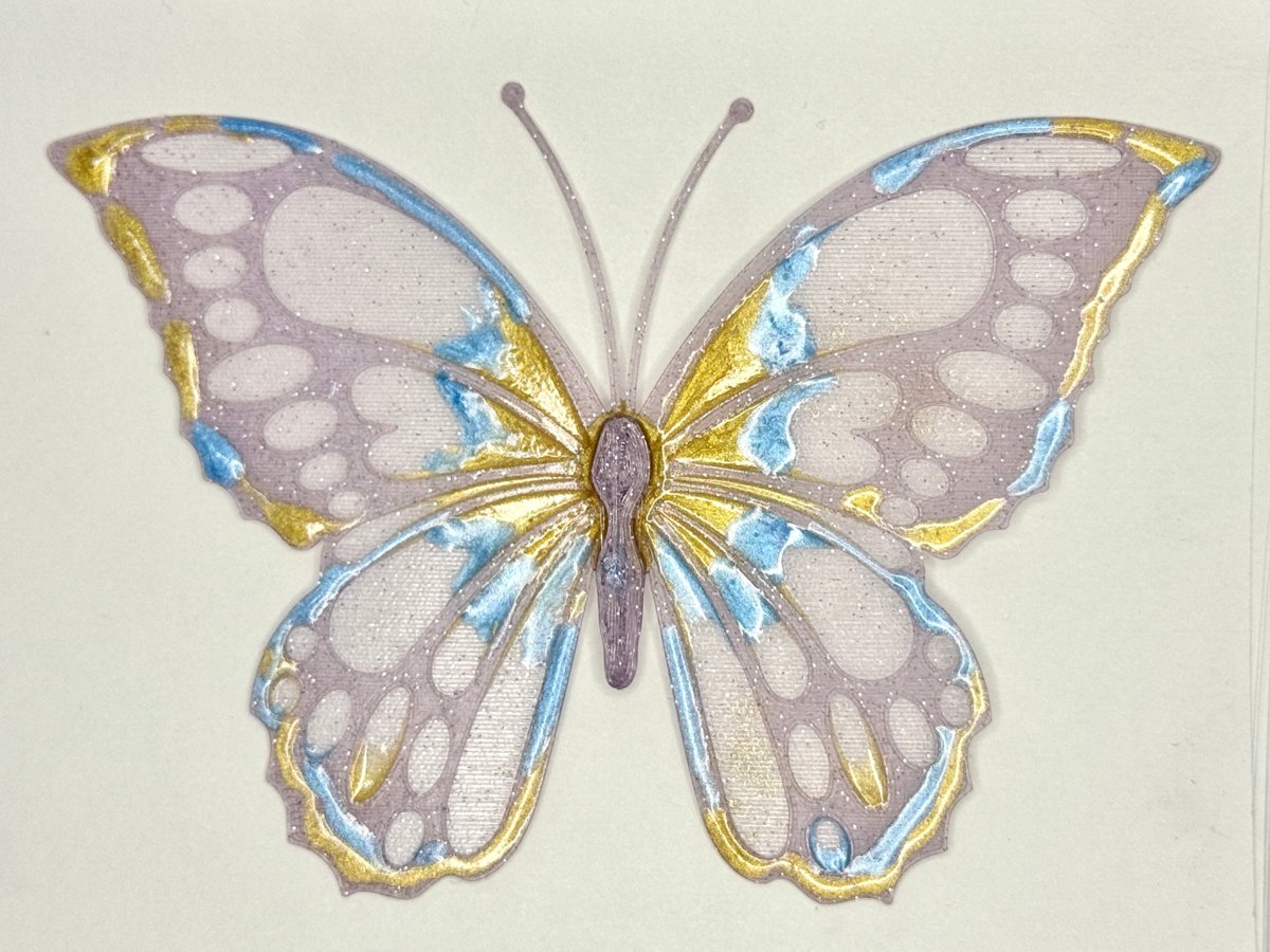 A 3D-printed butterfly finished with resin and gold powder