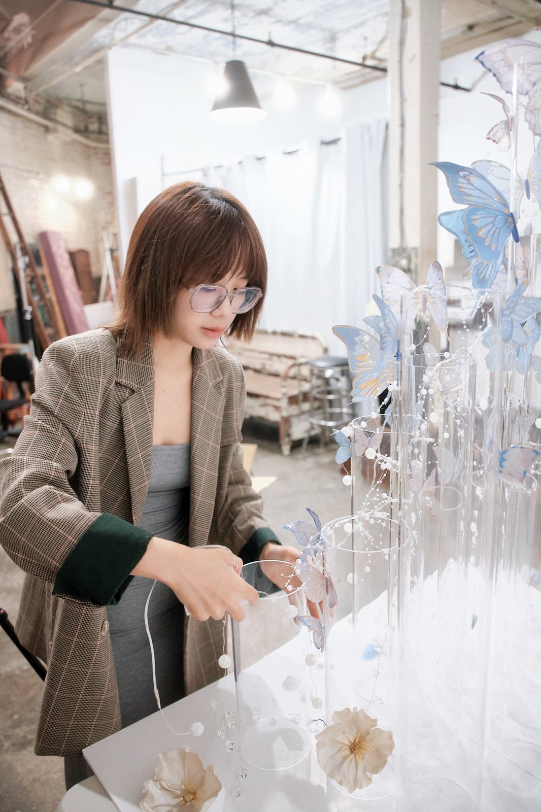 Threading strands of pearls between the acrylic columns